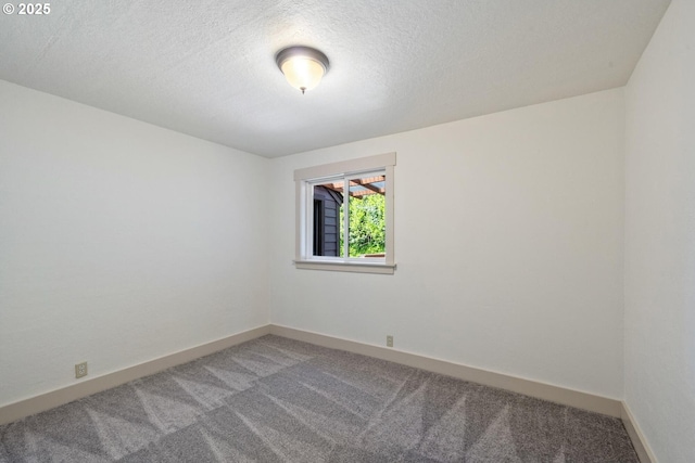 512 Evergreen Dr, Tillamook, OR 97141 - empty room featuring light carpet, a textured ceiling, and baseboards