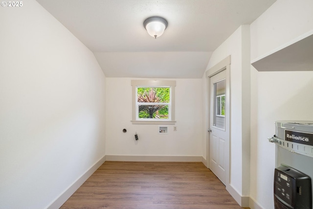 512 Evergreen Dr, Tillamook, OR 97141 - empty room with wood finished floors, baseboards, and lofted ceiling