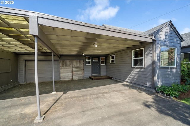512 Evergreen Dr, Tillamook, OR 97141 - view of patio featuring an attached carport, concrete driveway, and a garage