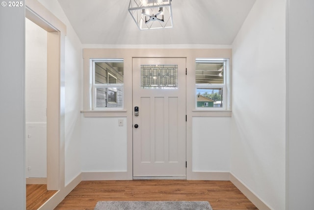 512 Evergreen Dr, Tillamook, OR 97141 - entrance foyer featuring a chandelier, lofted ceiling, and wood finished floors
