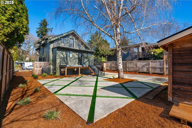 3660 SE Henderson St, Portland, OR 97202 - exterior space with stairway, a fenced backyard, and central AC