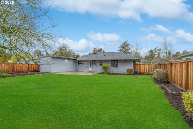 rear view of property featuring a yard, a chimney, a patio area, and a fenced backyard