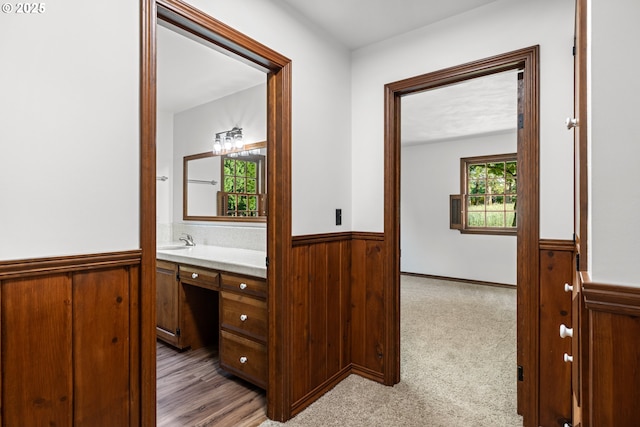 17753 Powers Creek Loop Rd, Silverton, OR 97381 - hall with a wainscoted wall, wooden walls, an office area, and light carpet