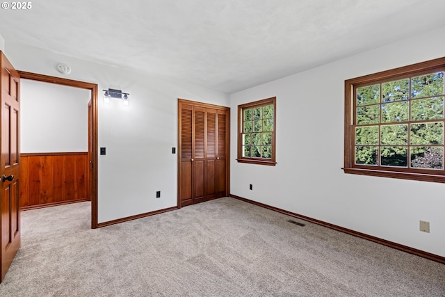 17753 Powers Creek Loop Rd, Silverton, OR 97381 - unfurnished room with healthy amount of natural light, light carpet, a smoke detector, wooden walls, and a wainscoted wall