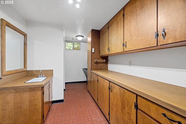 17753 Powers Creek Loop Rd, Silverton, OR 97381 - kitchen featuring brick patterned flooring, light countertops, and brown cabinets
