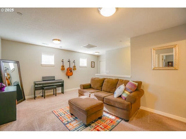 living room featuring light colored carpet, visible vents, and baseboards