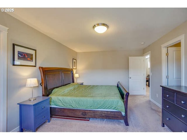 bedroom with light carpet and baseboards