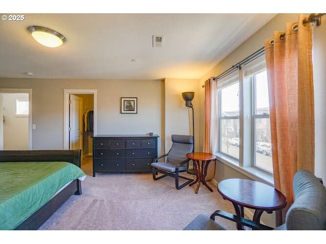 bedroom featuring light colored carpet and visible vents