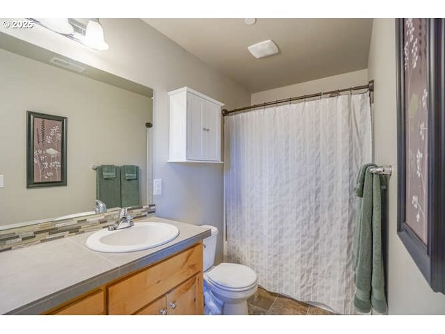 bathroom featuring visible vents, vanity, and toilet