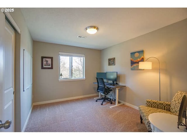 office featuring carpet flooring, visible vents, and baseboards