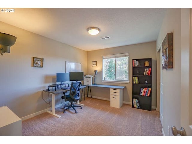 office with light carpet and baseboards