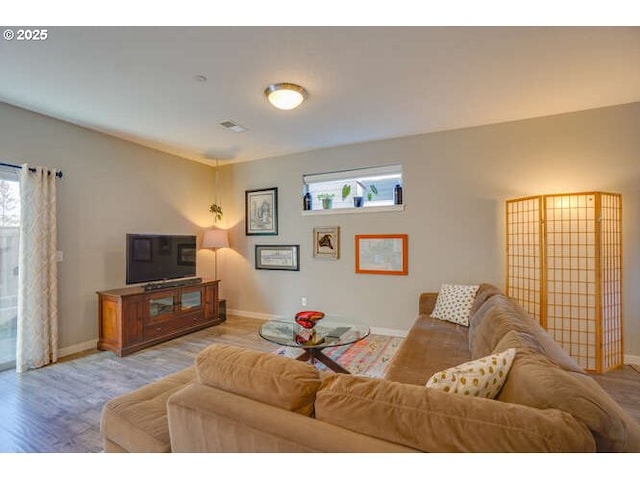 living room with light wood finished floors and baseboards