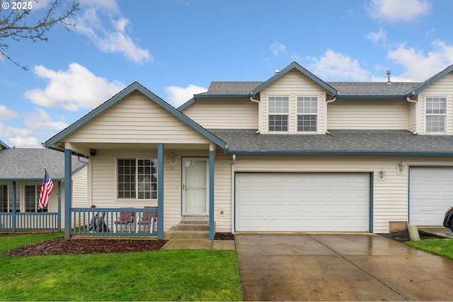 view of front of house featuring a front yard, a porch, and a garage