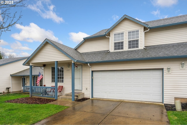 view of front facade featuring a front yard, a porch, and a garage