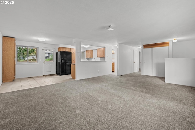 345 S 11th St, Saint Helens, OR 97051 - unfurnished living room featuring light carpet and light tile patterned flooring