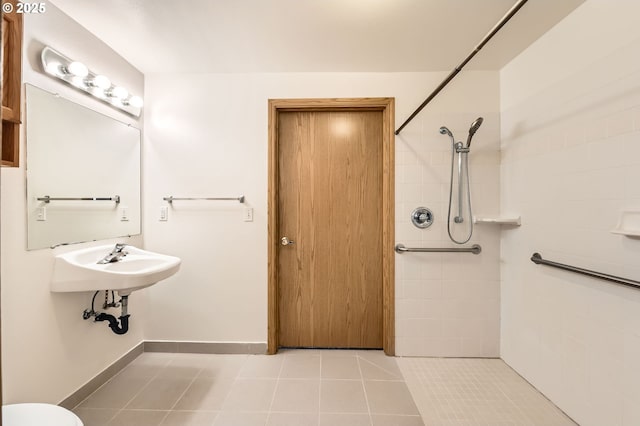 1006 NE 45th St, Vancouver, WA 98663 - bathroom featuring a tile shower, tile patterned flooring, baseboards, and a sink