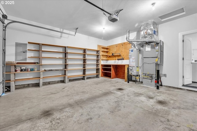 garage featuring water heater and a garage door opener