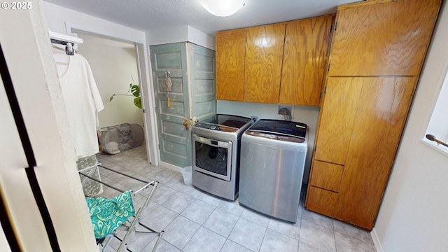 95169 Vista Loop, Gold Beach, OR 97444 - laundry room with cabinet space, separate washer and dryer, light tile patterned floors, and baseboards