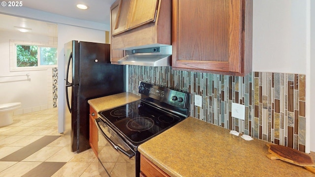 95169 Vista Loop, Gold Beach, OR 97444 - kitchen featuring range with electric cooktop, exhaust hood, decorative backsplash, brown cabinets, and freestanding refrigerator