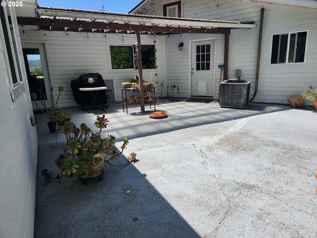 95169 Vista Loop, Gold Beach, OR 97444 - view of patio featuring a pergola, central air condition unit, and area for grilling