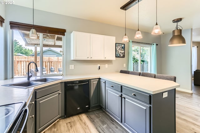 1219 34th Pl, Forest Grove, OR 97116 - kitchen with gray cabinetry, dishwasher, a peninsula, white cabinets, and light wood-style floors