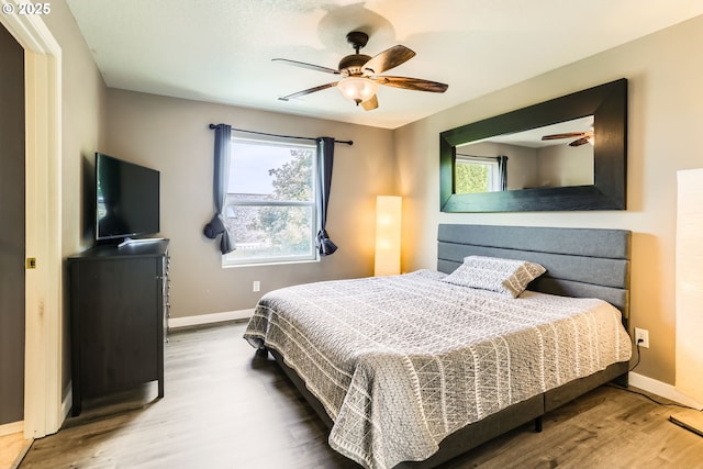 1219 34th Pl, Forest Grove, OR 97116 - bedroom with wood finished floors, multiple windows, and a ceiling fan