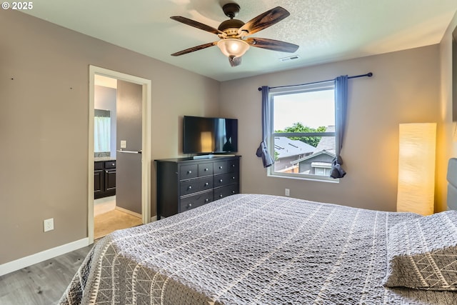 1219 34th Pl, Forest Grove, OR 97116 - bedroom featuring wood finished floors, connected bathroom, and a ceiling fan