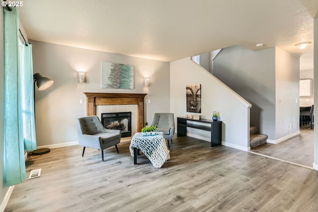 1219 34th Pl, Forest Grove, OR 97116 - living area featuring stairs, light wood finished floors, and a tile fireplace