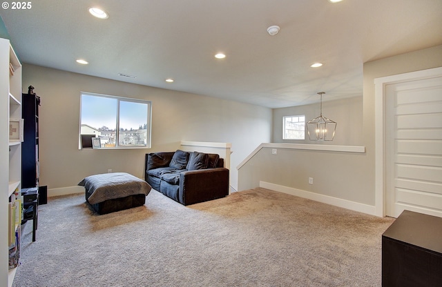 sitting room with light colored carpet and a chandelier