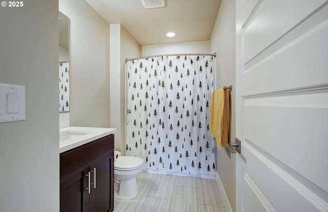 bathroom featuring vanity, a shower with shower curtain, and toilet