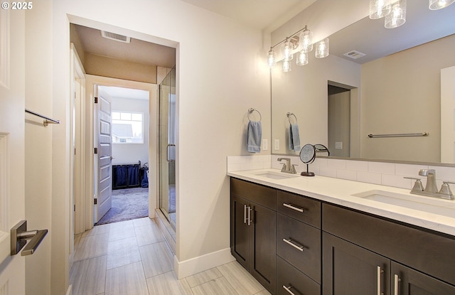 bathroom featuring vanity and a shower with shower door