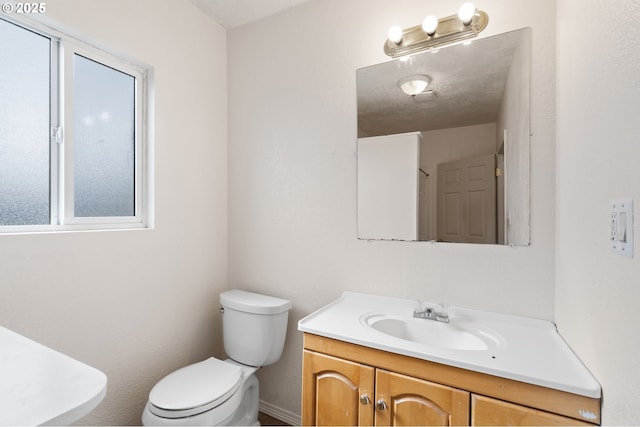 half bath with vanity and toilet