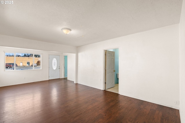 entrance foyer featuring a textured ceiling and wood finished floors