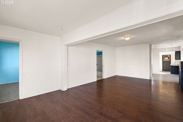 spare room with a sink and wood finished floors