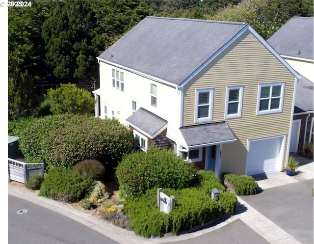 view of front of property featuring aphalt driveway and an attached garage