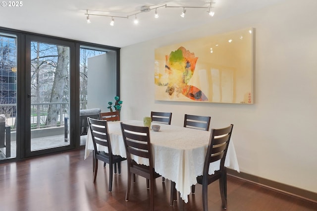 dining space featuring dark hardwood / wood-style floors and expansive windows