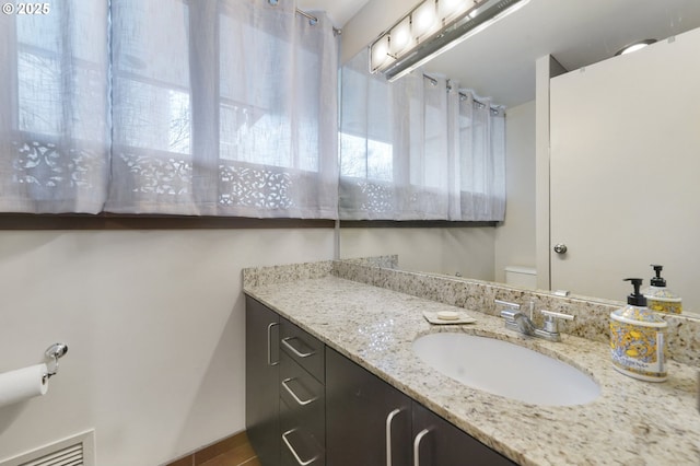 bathroom with toilet and vanity