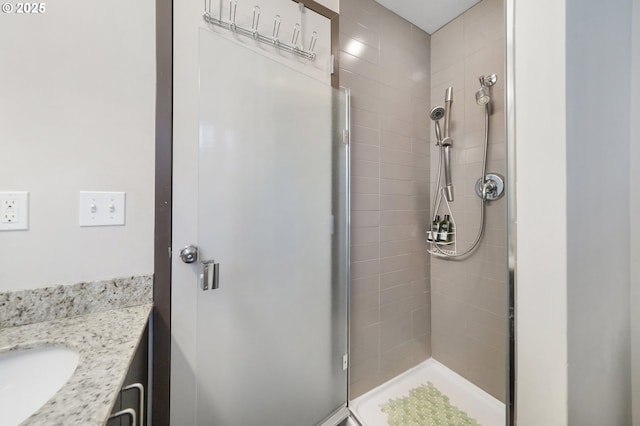 bathroom with vanity and a shower with door