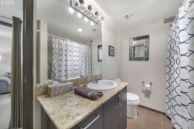 bathroom featuring toilet, vanity, and tile patterned floors