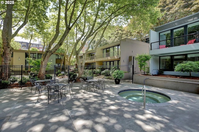 view of pool with a patio area and a hot tub