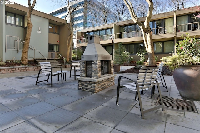 view of patio with an outdoor stone fireplace