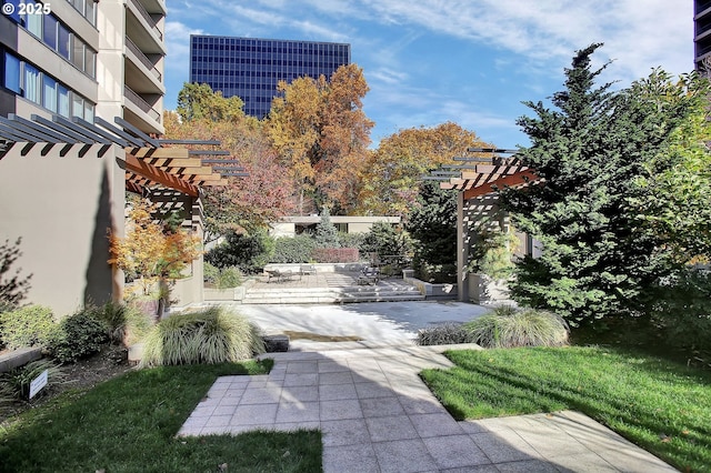 view of yard with central air condition unit, a pergola, and a patio area