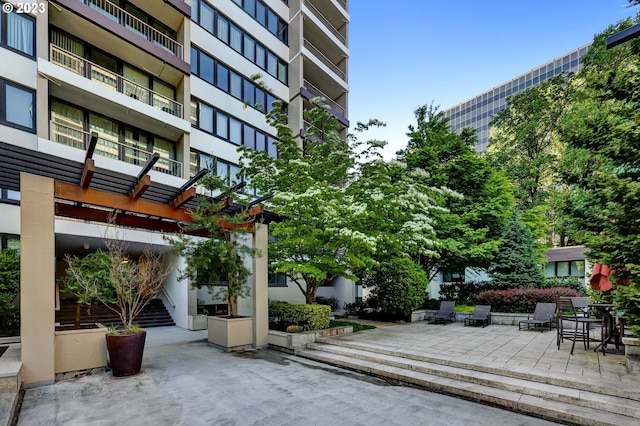 view of property's community featuring a patio area and a pergola