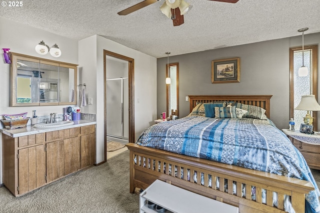 carpeted bedroom featuring ceiling fan, sink, and a textured ceiling