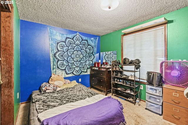 bedroom featuring carpet and a textured ceiling