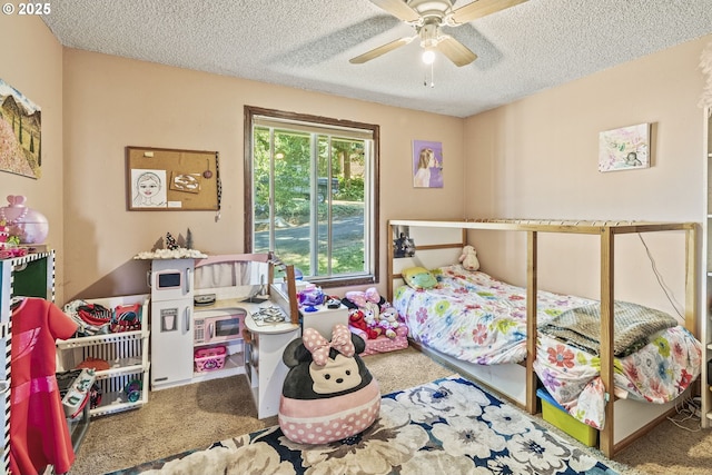 carpeted bedroom featuring ceiling fan and a textured ceiling