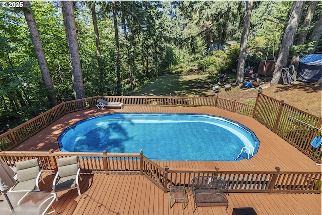 view of swimming pool featuring a wooden deck