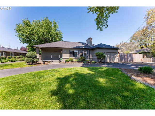 single story home featuring fence, a garage, a front lawn, and aphalt driveway