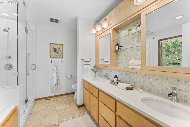 1281 NE Zachary St, Hillsboro, OR 97124 - full bathroom with double vanity, a stall shower, tasteful backsplash, toilet, and baseboards