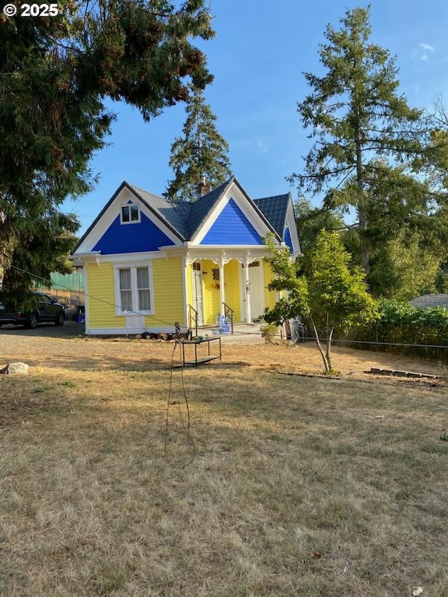 view of front facade featuring a front yard and fence